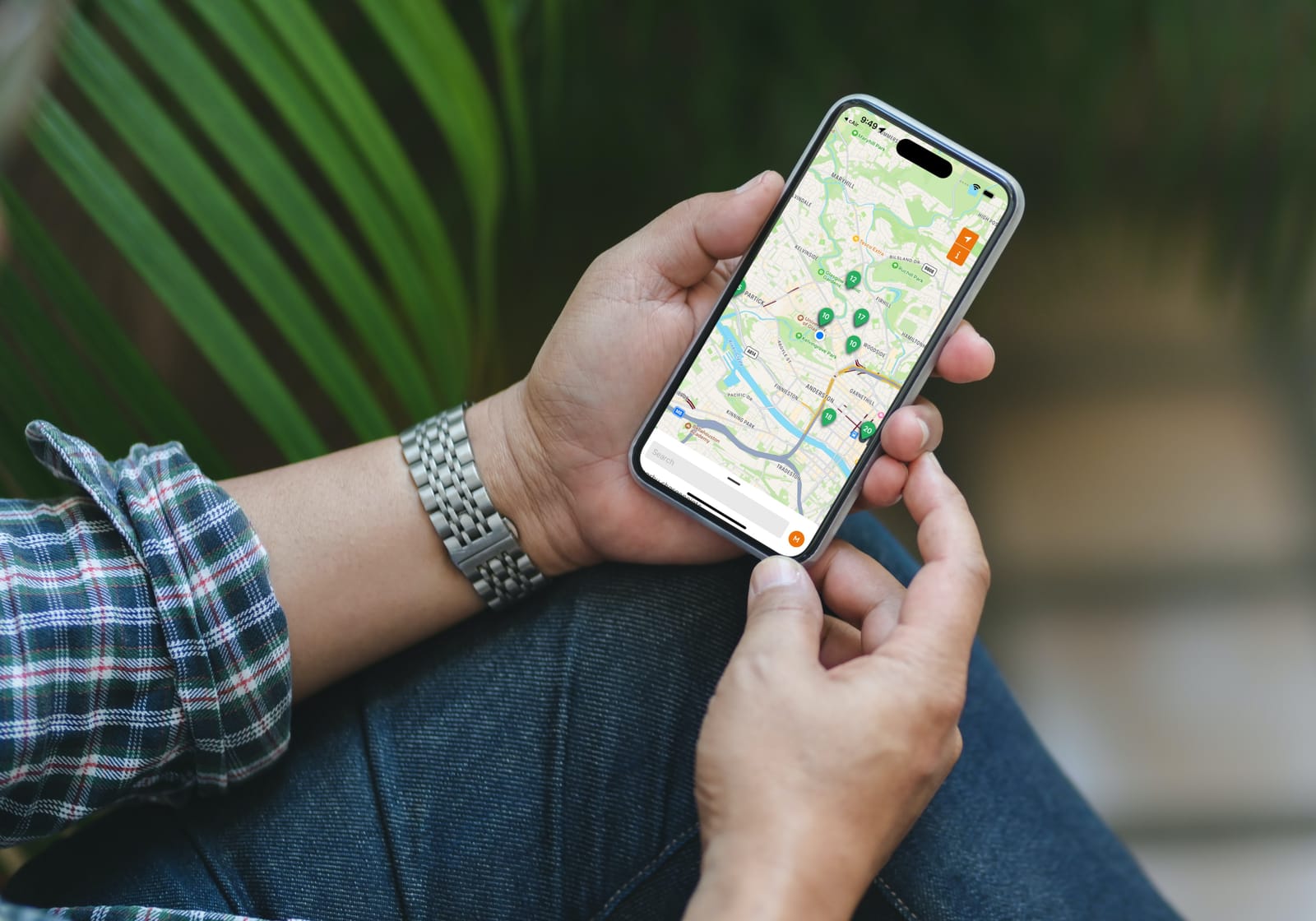 Hands holding a phone showing the Urban Fox app with nearby chargepoints on a map